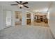 The kitchen with wooden cabinets, stainless appliances, and tile floor connects to the living area at 18618 E Mockingbird Dr, Queen Creek, AZ 85142
