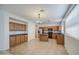 Spacious kitchen features wooden cabinets, an island, and tile flooring at 18618 E Mockingbird Dr, Queen Creek, AZ 85142