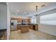 Kitchen boasts stainless steel appliances, wooden cabinets, an island, and tile flooring at 18618 E Mockingbird Dr, Queen Creek, AZ 85142