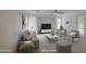 Well-lit living room with modern furniture, neutral colors, and a ceiling fan at 18618 E Mockingbird Dr, Queen Creek, AZ 85142