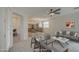Open-concept living space with kitchen, dining, and living areas under a ceiling fan for better airflow at 18618 E Mockingbird Dr, Queen Creek, AZ 85142