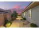 Manicured backyard featuring a paved walkway, verdant landscaping, and a serene atmosphere at 18635 W Miami St, Goodyear, AZ 85338