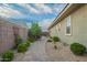 Beautiful backyard featuring a paved path, lush landscaping, and a peaceful outdoor setting at 18635 W Miami St, Goodyear, AZ 85338