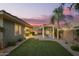Expansive backyard featuring a covered patio, pergola, lush lawn, and vibrant landscaping at 18635 W Miami St, Goodyear, AZ 85338