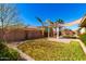 Spacious backyard features a grassy lawn, patio with pergola, and privacy wall, ideal for outdoor relaxation at 18635 W Miami St, Goodyear, AZ 85338