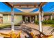 Backyard view featuring covered outdoor living space with firepit and outdoor seating area at 18635 W Miami St, Goodyear, AZ 85338