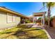 Backyard featuring manicured lawn, a covered patio and pergola with outdoor seating area at 18635 W Miami St, Goodyear, AZ 85338