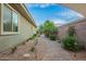 Well-kept backyard with a paved walkway, manicured landscaping, and serene outdoor space at 18635 W Miami St, Goodyear, AZ 85338