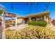 Backyard view featuring a covered patio, grassy area, lush landscaping and outdoor pergola at 18635 W Miami St, Goodyear, AZ 85338