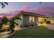 Well-maintained backyard showcasing a covered patio, vibrant greenery, and meticulous landscaping at 18635 W Miami St, Goodyear, AZ 85338