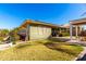 Backyard view featuring covered patio, manicured lawn, and outdoor seating area under pergola at 18635 W Miami St, Goodyear, AZ 85338