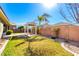 Backyard featuring manicured lawn, covered patio and pergola with seating area for entertaining at 18635 W Miami St, Goodyear, AZ 85338