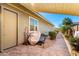 Backyard view with covered patio, stone tile, grass and rock landscaping at 18635 W Miami St, Goodyear, AZ 85338