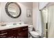 Bathroom featuring a decorative mirror, a cherry wood vanity and shower with curtain at 18635 W Miami St, Goodyear, AZ 85338