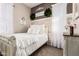 Cozy bedroom with a white bed, sheer curtains, and decorative wall decor at 18635 W Miami St, Goodyear, AZ 85338