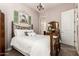 Cozy bedroom with an antique-style bed, decorative accents, and an ensuite bathroom at 18635 W Miami St, Goodyear, AZ 85338