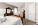 Spacious bedroom with dark wood furniture, plush white bedding, and neutral wall colors at 18635 W Miami St, Goodyear, AZ 85338