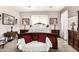 Ornate bedroom features a carved wood bed frame, plush pillows, and decorative wall art at 18635 W Miami St, Goodyear, AZ 85338