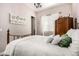 Comfortable bedroom featuring soft lighting, ample closet space and a wrought iron bed frame at 18635 W Miami St, Goodyear, AZ 85338