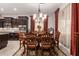 Elegant dining room featuring a chandelier, formal dining set, and stylish décor, adjacent to the kitchen at 18635 W Miami St, Goodyear, AZ 85338