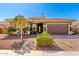 Charming home with manicured landscaping, a paver driveway, and an American flag on a clear, blue-sky day at 18635 W Miami St, Goodyear, AZ 85338