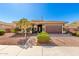 Charming home with manicured landscaping, a paver driveway, and an American flag on a clear, blue-sky day at 18635 W Miami St, Goodyear, AZ 85338