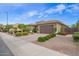 Charming single-Gathering home with a well-manicured lawn, a desert landscape, and a two-car garage at 18635 W Miami St, Goodyear, AZ 85338