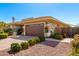 Side view of earth-toned home with manicured landscaping, gravel, and an American flag on a clear, blue-sky day at 18635 W Miami St, Goodyear, AZ 85338