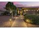 Charming single-Gathering home featuring a well-lit walkway, inviting landscaping, and a two-car garage at 18635 W Miami St, Goodyear, AZ 85338