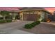 Home exterior showcasing a two-car garage, desert landscaping, and manicured front yard at 18635 W Miami St, Goodyear, AZ 85338