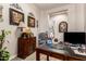 Home office featuring custom built ins, neutral tones, and decorative artwork at 18635 W Miami St, Goodyear, AZ 85338