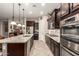 Modern kitchen with a large island, stainless steel appliances, and ample cabinet space, perfect for cooking at 18635 W Miami St, Goodyear, AZ 85338
