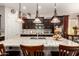 Bright kitchen featuring a large granite island, stainless steel appliances, and pendant lights at 18635 W Miami St, Goodyear, AZ 85338