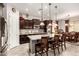 Open kitchen with stainless steel appliances, granite countertops, and a breakfast bar at 18635 W Miami St, Goodyear, AZ 85338