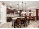 Spacious kitchen with granite countertops, stainless steel appliances, and a large center island with seating at 18635 W Miami St, Goodyear, AZ 85338