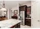 Well-equipped kitchen with stainless steel refrigerator, breakfast bar, and modern cabinetry at 18635 W Miami St, Goodyear, AZ 85338