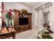 Cozy living room with custom-built cabinet and neutral walls enhanced by natural lighting at 18635 W Miami St, Goodyear, AZ 85338