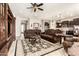 Spacious living room with hardwood furniture, a ceiling fan, and views of the kitchen and entryway at 18635 W Miami St, Goodyear, AZ 85338