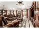 Cozy living room with hardwood furniture, a ceiling fan, and views of the kitchen and dining area at 18635 W Miami St, Goodyear, AZ 85338