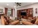 Spacious living room with a large entertainment center and sliding glass doors at 18635 W Miami St, Goodyear, AZ 85338