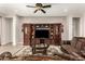 Spacious living room featuring custom entertainment center, ceiling fan and elegant decor at 18635 W Miami St, Goodyear, AZ 85338