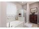 Elegant bathroom with a soaking tub, separate shower, and stylish fixtures at 18635 W Miami St, Goodyear, AZ 85338
