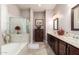 Luxurious bathroom features dual sinks, a soaking tub, and a separate shower at 18635 W Miami St, Goodyear, AZ 85338