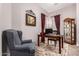 Cozy office features a wooden desk, comfortable chair, and ornate display cabinet at 18635 W Miami St, Goodyear, AZ 85338