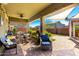 Relaxing covered patio boasts ample seating, ceiling fan, and string lights for comfortable outdoor living at 18635 W Miami St, Goodyear, AZ 85338