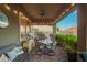 Charming covered patio with dining set, grill, and outdoor seating, great for entertaining guests at 18635 W Miami St, Goodyear, AZ 85338