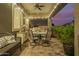 Cozy covered patio with a dining set, grill, and outdoor storage, perfect for evening relaxation at 18635 W Miami St, Goodyear, AZ 85338