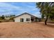 View of backyard with sliding doors, covered patio, and low maintenance desert landscaping at 18829 N 15Th Pl, Phoenix, AZ 85024