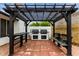 Outdoor kitchen and dining area with built-in barbecue and pergola at 18829 N 15Th Pl, Phoenix, AZ 85024