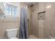 Modern bathroom featuring tiled shower with a decorative shower curtain and mosaic accents at 18829 N 15Th Pl, Phoenix, AZ 85024